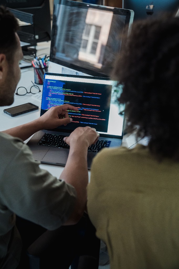 Engineers reviewing code together during a product session